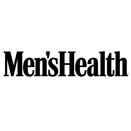 A man is standing up in front of the words men 's health.